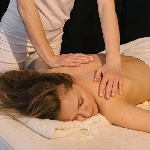 A woman receiving a soothing back massage