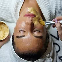 A woman receiving a facial treatment