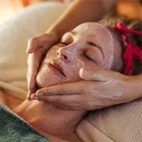 A woman receiving a facial treatment