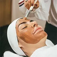 A woman receiving a facial treatment