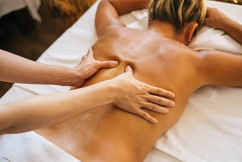 A woman enjoys a soothing back massage