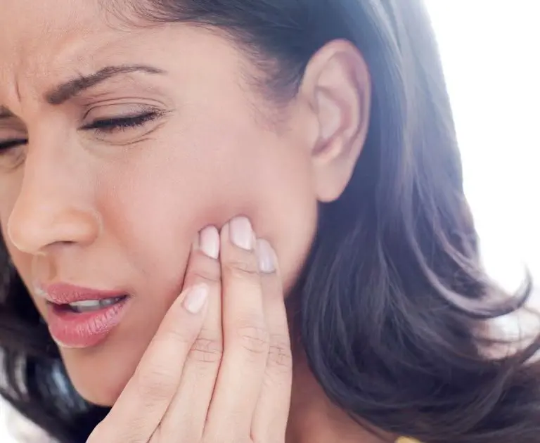 A woman receiving a soothing facial massage,