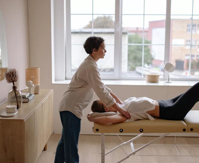 woman on massage table getting a massage by another woman